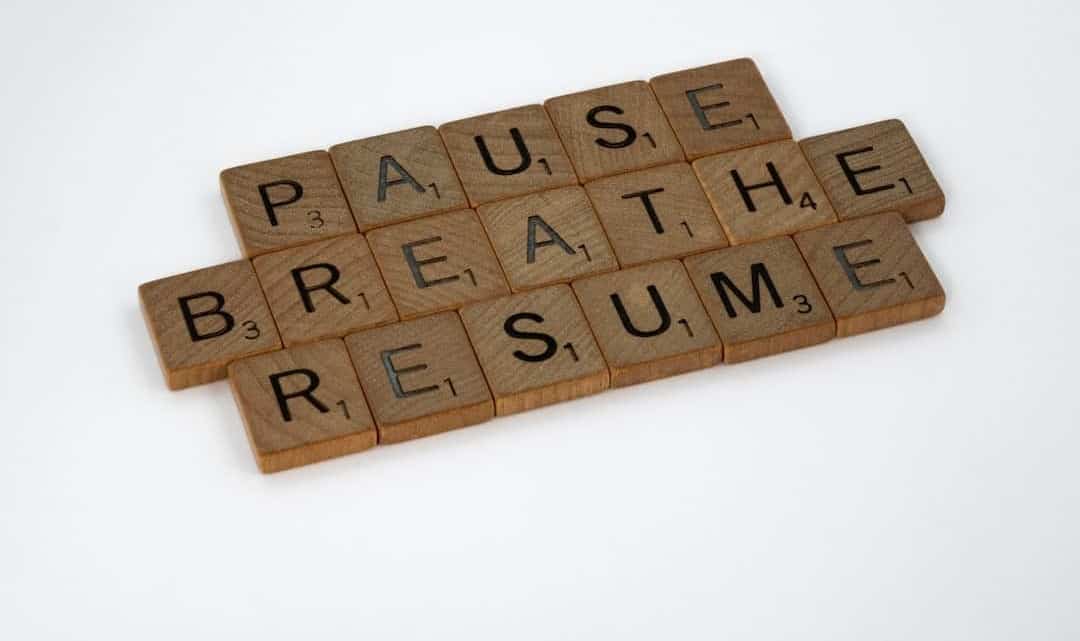 Image which says, "Pause, Breath, Resume" with each letter written on individual wooden blocks.